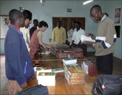 Students receiving books